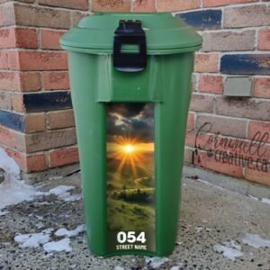 Sun rises over a hillside with grassy fields Green Bin Sticker